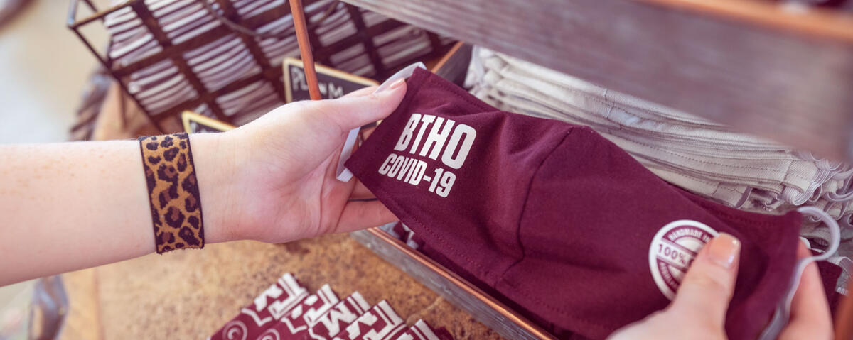 close-up photo of a maroon BTHO COVID-19 face mask